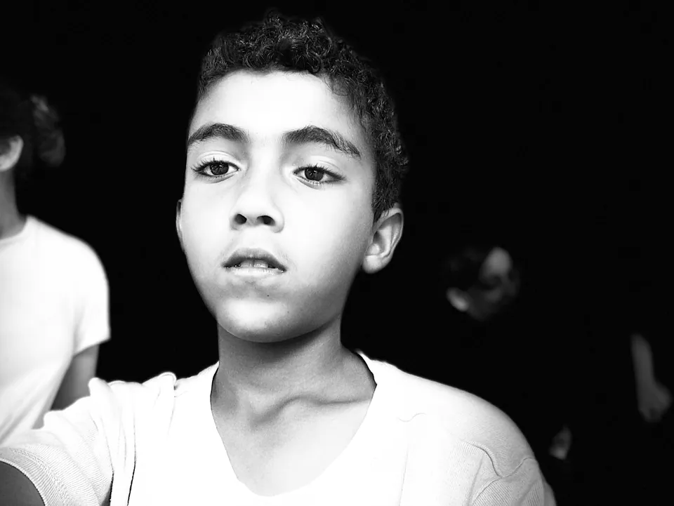 Black and white portrait of a boy looking just past the camera
