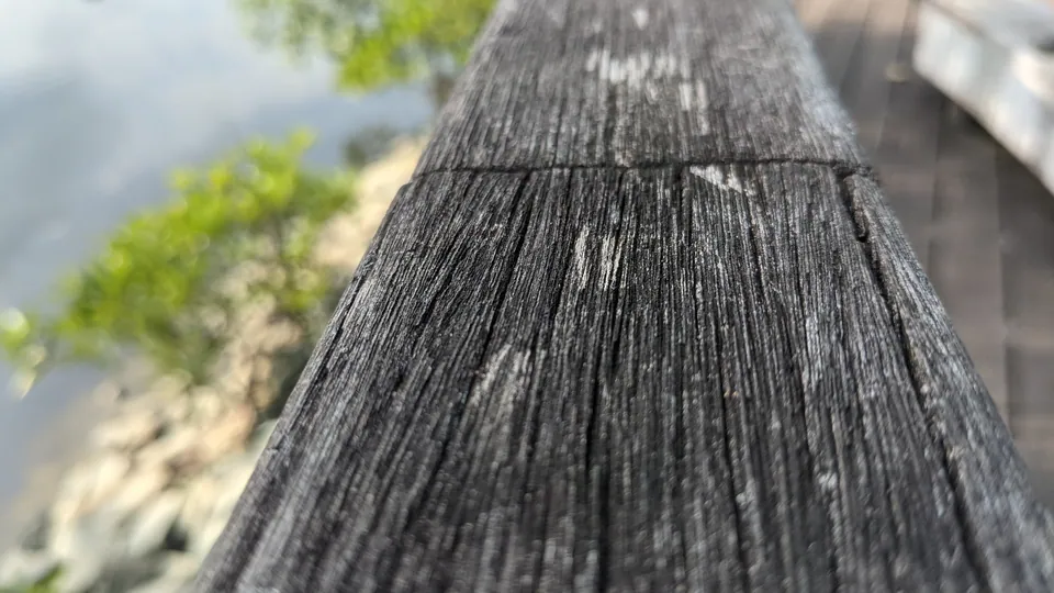 A weathered wooden beam stretching away from the camera