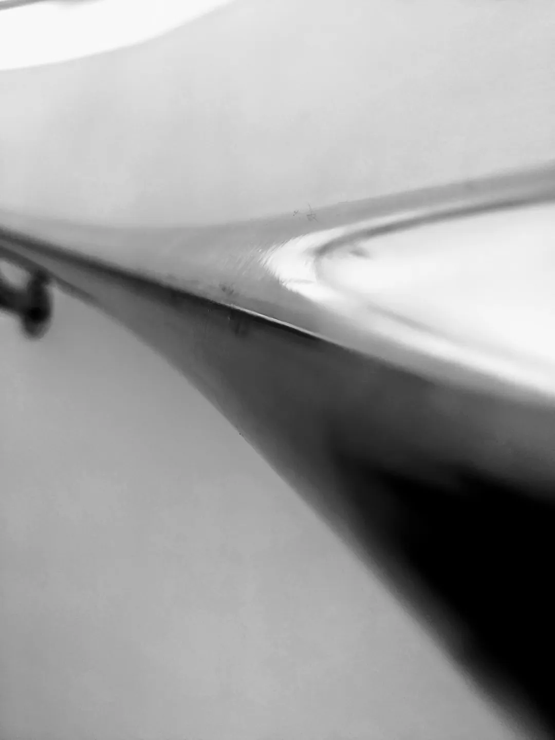 A handrail sweeping around a white curved stairwell