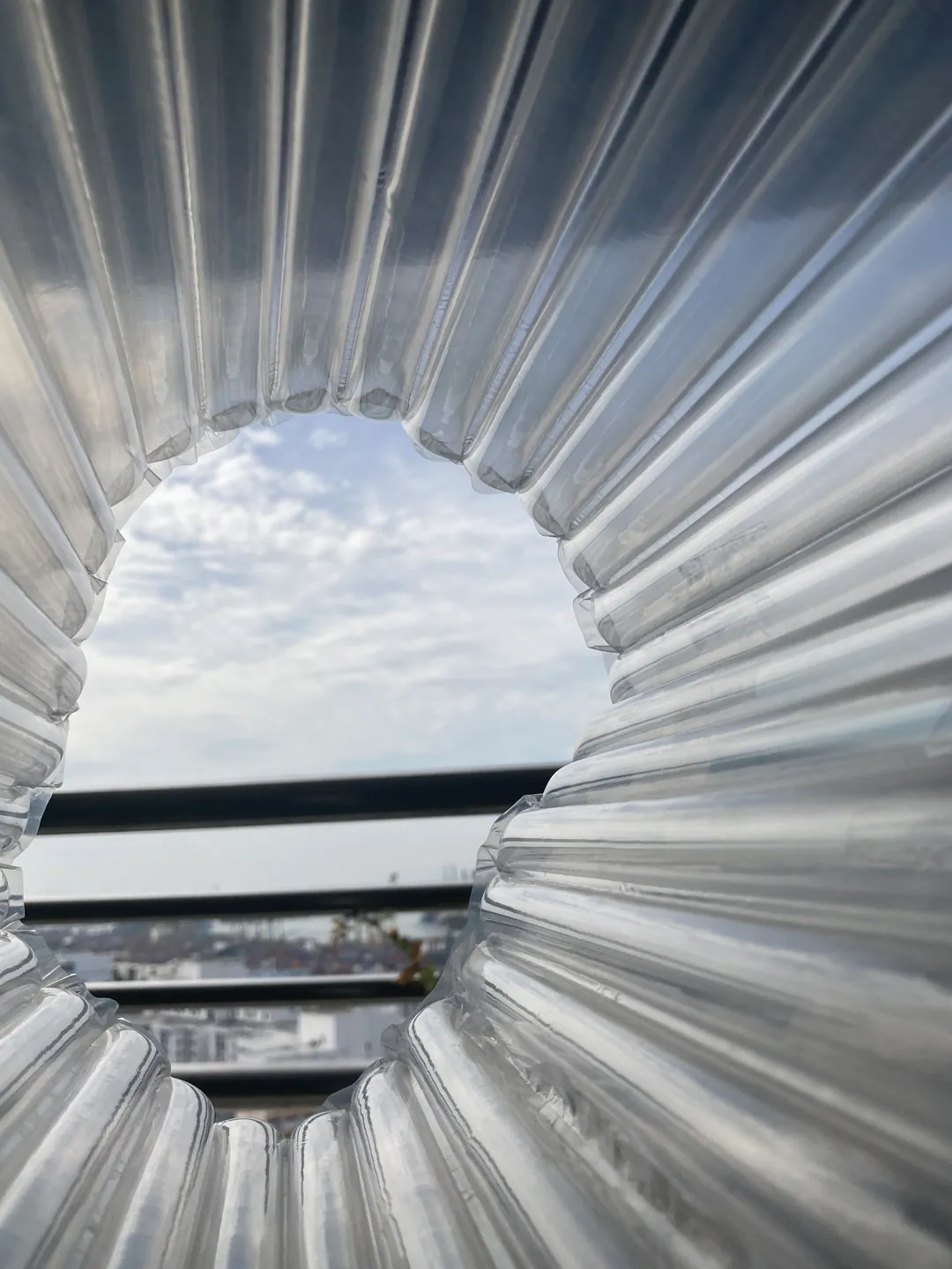 Ribbed metal folds forming a round opening onto the sky